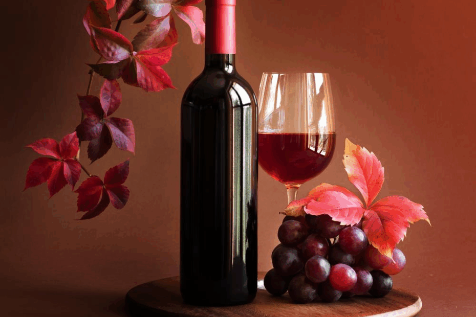 Copa de vino tinto servida junto a una botella sobre una mesa elegante, representando la calidad de los vinos en Barcelona Wines Online.